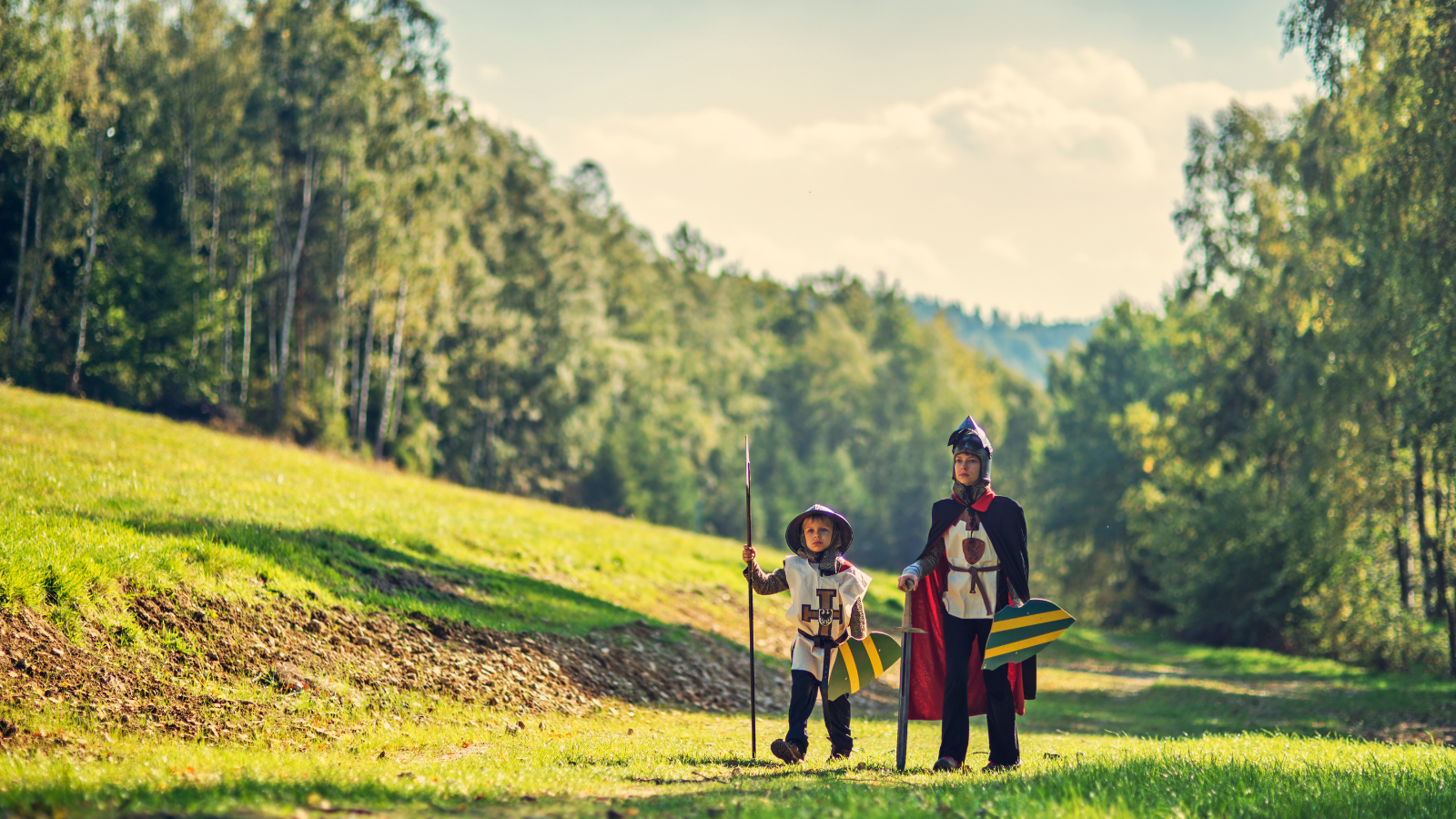 A young Knight and his page traversing the countryside.