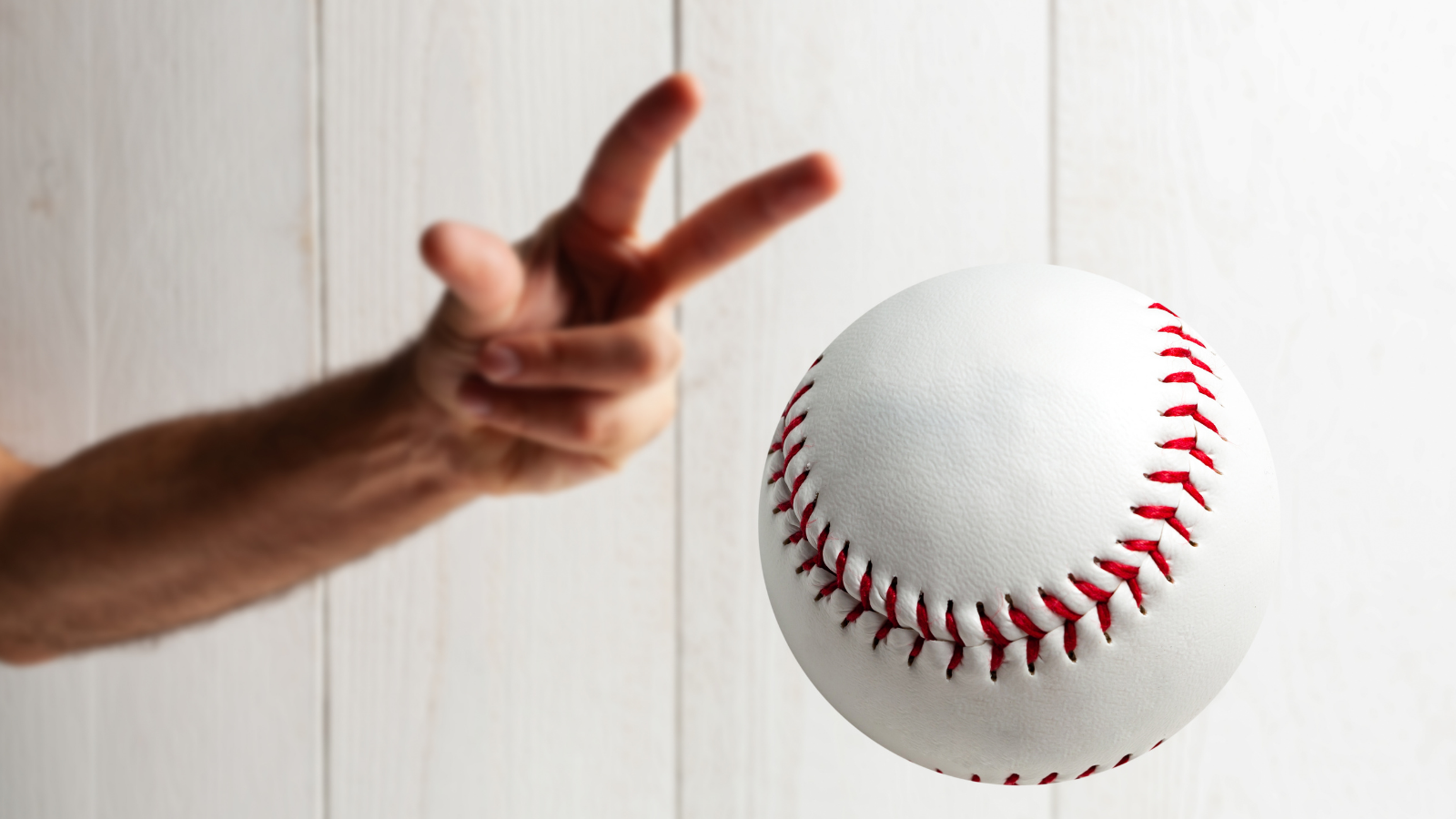 A baseball pitcher tossing a curve ball.