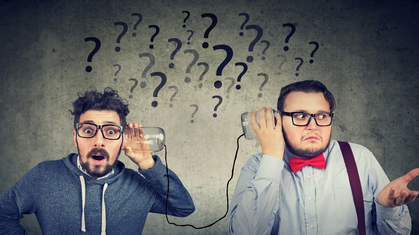 Two confused guys holding jars connected by a string to their ears.